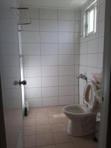 uma casa de banho branca com um WC e uma janela em Lai Yi Ke B&B em Dongshan