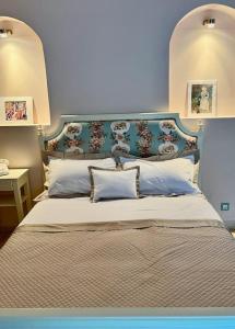 a bedroom with a large bed with a blue headboard at Unique, luxurious coastal villa in beautiful Anidri, Paleochora in Palaiochora