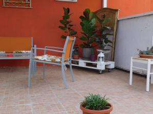 a patio with a chair and potted plants at Tenuta Palladini 5 chilometri da porto cesario in Leverano