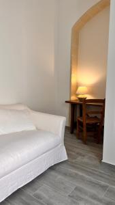 uma cama branca numa sala com uma mesa em Dimora Donna Vitalia Apartments em Érice