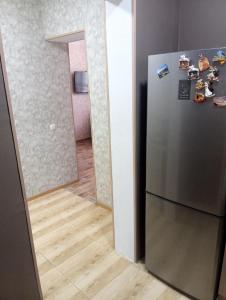 a kitchen with a stainless steel refrigerator and a hallway at Art-Rabath in Akhaltsikhe