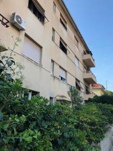 an apartment building with trees in front of it at Designer Two-Bedroom Apartment in Split
