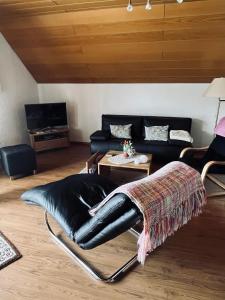 - un salon avec un canapé en cuir et une table dans l'établissement Ferienwohnung Poczewski, à Kevelaer