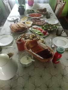 a table with plates of food on a table at Agroturystyka u Basi in Burniszki