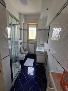 a bathroom with a toilet and a sink and a shower at La dimora dei Cedri Argentati in Rome
