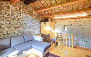 a living room with a couch and a stone wall at Awesome Home In Premariacco With Wifi in Premariacco