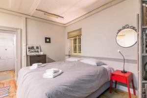 a bedroom with a bed and a red table at Pentofanoro Central Studio - Corfu Cozy Getaway in Corfu Town