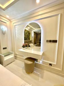 a bedroom with a large mirror and a bed at Emeralds Villa Islamabad in Islamabad