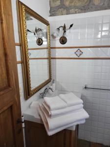 AlleronaCountry House La Collina di Bargiano - Casa Raffaella的浴室设有镜子、水槽和毛巾