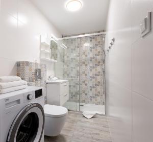 a white bathroom with a toilet and a shower at ApartamentyGdanskEU - Mieszkanie Mewa in Sopot +14 photos