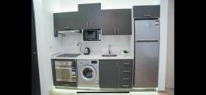 a kitchen with a refrigerator and a washing machine at Binishty hurghada apartment in Hurghada