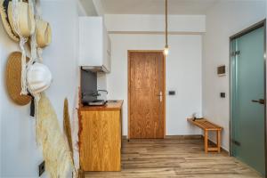 a kitchen with a wooden door and a wooden floor at Amoudi Studios Apartments Hotel in Amoudi