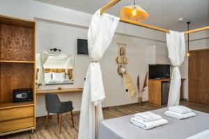a room with a bed and a mirror at Amoudi Studios Apartments Hotel in Amoudi