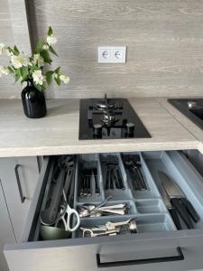a kitchen with a stove top oven in a drawer at TK apartamenti in Rēzekne