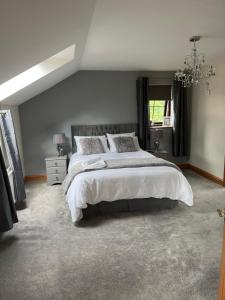 a bedroom with a large bed and a window at The Cottage in Carlisle