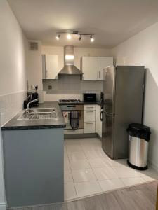 a kitchen with a stainless steel refrigerator and a sink at 31 Galleria Court in London