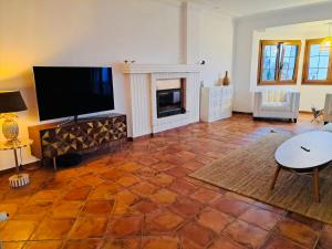 a living room with a flat screen tv and a fireplace at Sea view Villa La Alcaidesa in La Alcaidesa
