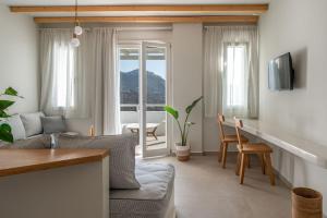 a living room with a couch and a table at Castello Amorgos Suites in Katapola