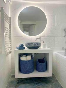a white bathroom with a sink and a mirror at Nouveau - Nice Mamac - centre in Nice