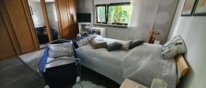 a bedroom with a bed with pillows on it at Schöne Ferienwohnung mit Terrasse und Garten in Überherrn