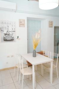 a white dining room with a white table and chairs at Casa Vacanze Le Cascate in Le Marmore