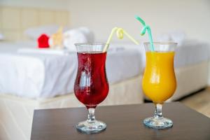 two cocktails in glasses sitting on a table at Guest House Elidis in Primorsko