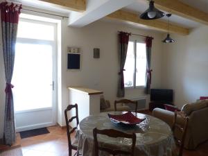 a living room with a table and a couch at Gîte du Pagoulin - Gîte in Hyères