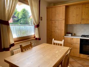 a kitchen with a wooden table and a window at Chalet Ceppo in Bormio
