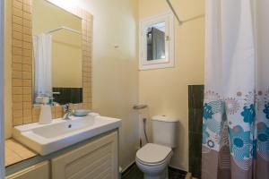 a bathroom with a sink and a toilet and a shower at CalmNature in Agnontas +42 photos