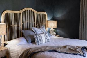a bedroom with a large bed with two lamps at Dal Zotto Homestead & Petite Retreats in Whitfield