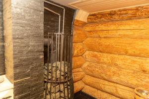 a shower in a bathroom with a stone wall at Pirtis pas Astą 