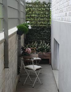 een patio met een tafel, stoelen en planten bij Enny Suite Apartment im schönen Rheinland in Lohmar