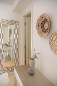 a dining room with a table and a mirror at Seacrete villas in Chania Town