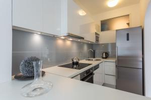a kitchen with a vase on a counter with a refrigerator at Villa AMICA in Zaton