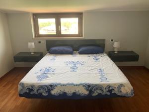 a bedroom with a large bed with two night stands at Attico The View in Pescara