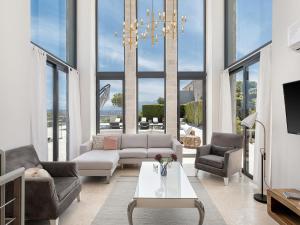 a living room with a couch and chairs and a table at Seacrete villas in Chania Town