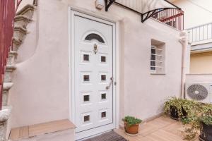 a white door of a house at Athina's little apartment in Thessaloniki