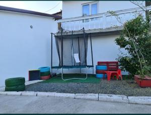 a house with a balcony with a net on it at Casa Bianca in Eforie Nord