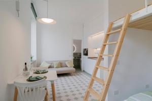 a living room with a ladder and a living room at Oliva Apartment in Imperia