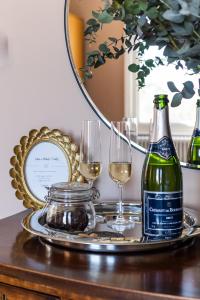 a table with two glasses and a bottle of wine at The Knowle at St Leonards in St. Leonards