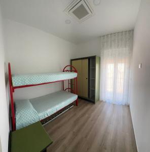 a room with two bunk beds and a window at LD Ianuzziello Residence - Jonica House in Scanzano