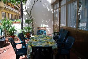 a table with chairs and a table cloth on a patio at Hotel Conchiglia in Montecatini Terme