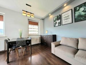 a living room with a table and a couch at Apartament Dark Chocolate 4 persons Down Town in Krakow