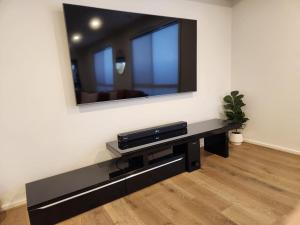 a living room with a television on a wall at Bullseye in Yarrawonga