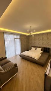 a large bedroom with a bed and a couch at Emela Villa in Sapanca +30 photos