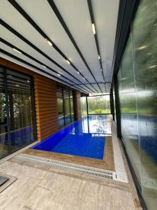 a swimming pool in the middle of a house at Emela Villa in Sapanca