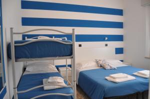 Postel nebo postele na pokoji v ubytování Hotel Susy - Ambienti rinnovati - direttamente su viale Dante e a due passi dal mare