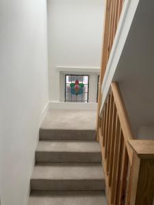 a staircase with a stained glass window in a house at Three Kings Luxe Escape in London