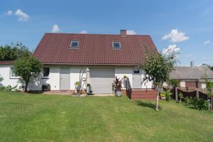 Merkinė的住宿－Dvi liepos，白色的房子,有红色的屋顶和院子