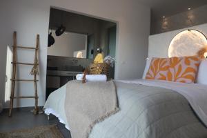 a bedroom with a large bed and a mirror at Villa Ktima Lipsi - Jacuzzi & Stunning Sea Sunsets in Klouvas